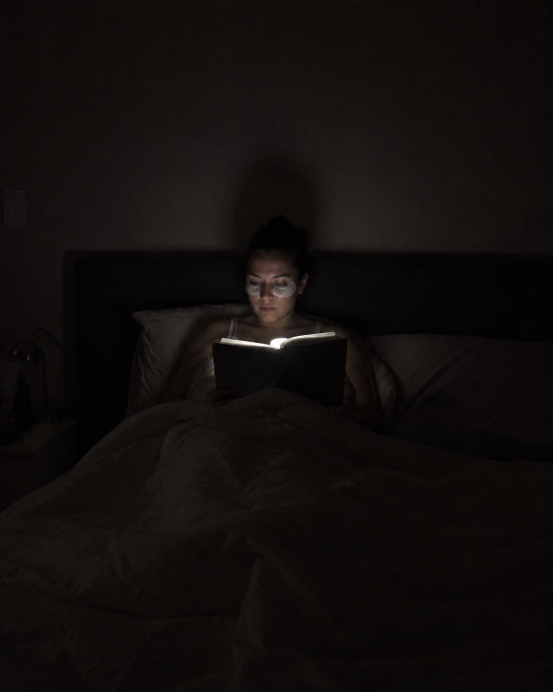Hand holding the lit PageLight reading light