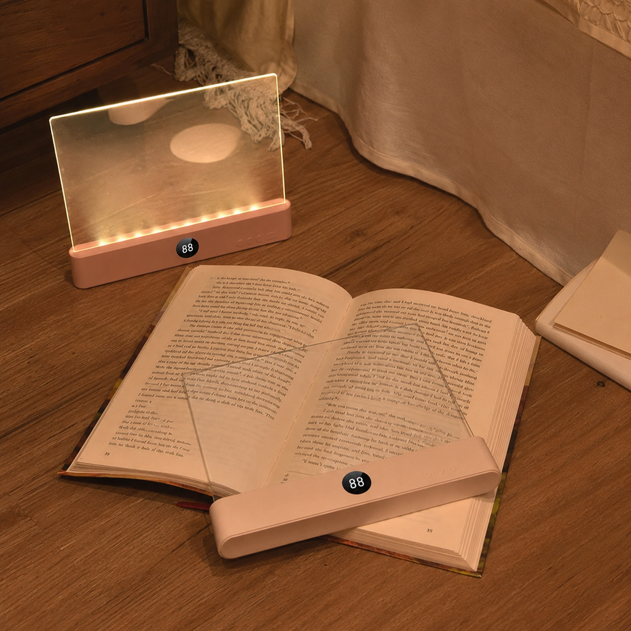Pink PageLight lit beside an open book at night